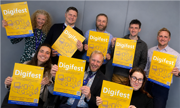 image of a group of the team holding Digifest notices