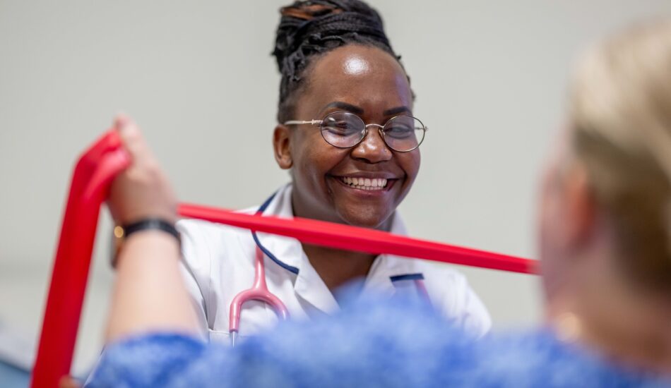 Healthcare professional supporting a patient during a therapy session