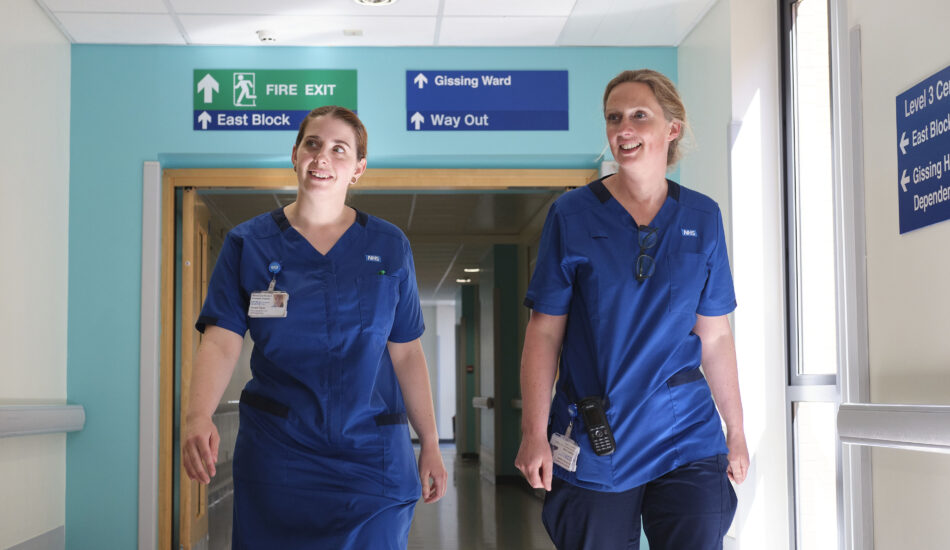 Two nurses in a corridor at NNUH
